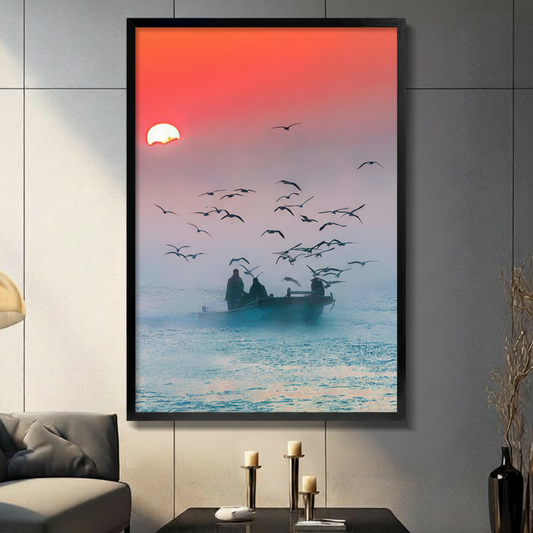 Fishermen silhouette on boat at sunrise surrounded by seagulls framed wall art - dramatic coastal photography style canvas print with coral red sky and misty teal ocean for living room decor