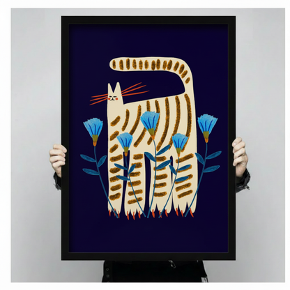 Folk art striped cat framed canvas art — tall cream tabby with golden brown stripes standing among vivid blue cornflowers on deep navy background, whimsical Scandinavian-inspired wall decor
