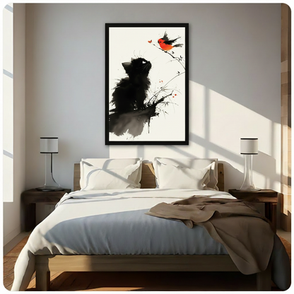 Chinese ink wash painting of a fluffy black kitten sitting and looking up at a small red robin on a bamboo branch against a warm cream textured background serene cat and bird wall art framed print above a bedroom with white linen bedding dark wood bed frame and white table lamps