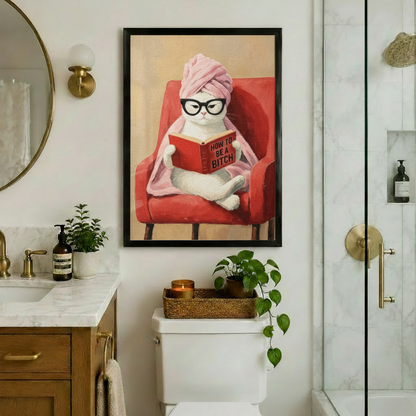Humorous framed canvas print of white cat wearing glasses and pink towel wrap reading a book in red armchair