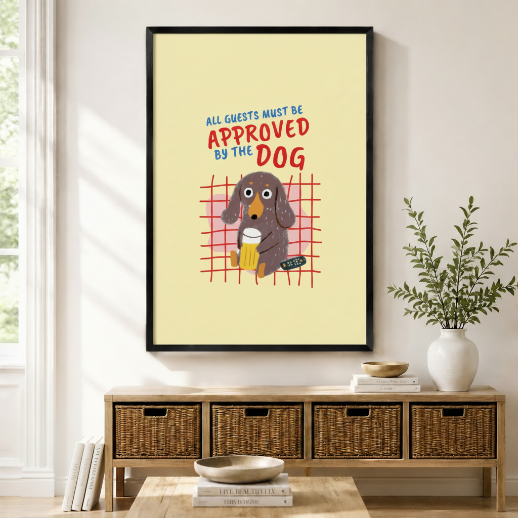 Funny dachshund wall art print in black frame displayed above a rattan sideboard in a bright living room – All Guests Must Be Approved By The Dog
