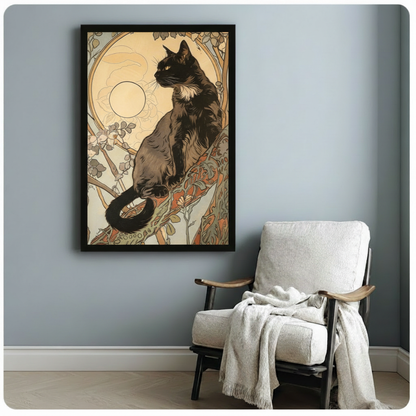 Elegant Art Nouveau black cat with curled tail on branch surrounded by ornamental floral tendrils and golden moon halo vintage illustration framed art poster displayed beside a white fabric lounge chair with draped throw blanket against a soft blue-gray wall