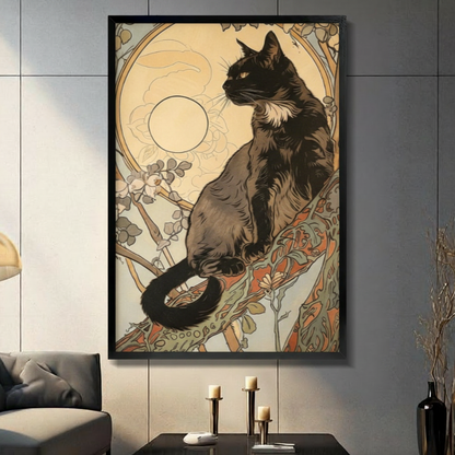 Art Nouveau black cat sitting on branch with full moon halo and ornate floral vine border in cream gold tones framed wall art print displayed in a living room with gray sofa, pillar candle holders, and black decorative vase against dark gray tiled wall
