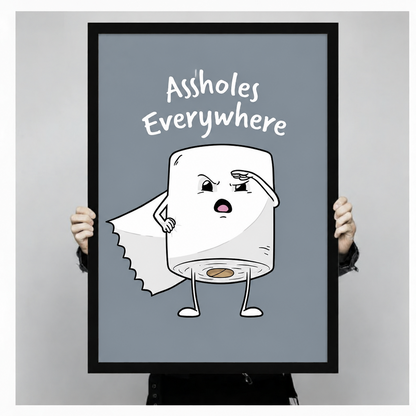 Person holding a large black-framed Assholes Everywhere toilet paper character art print showing size reference against a neutral grey background