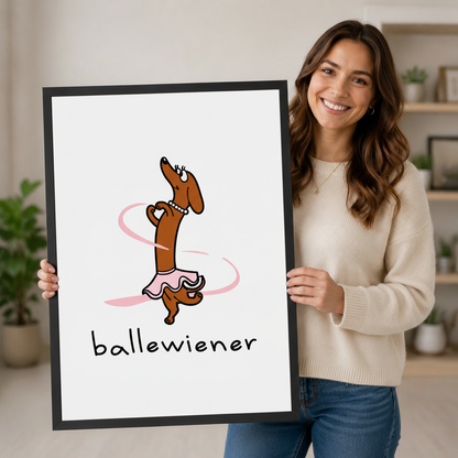 Smiling woman holding a large framed ballewiener dachshund ballet wall art print, showing black frame finish and print size with a home decor background