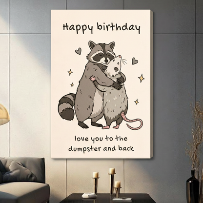 Gallery-wrapped stretched canvas of a chubby cartoon raccoon embracing an opossum surrounded by hearts and sparkles, funny birthday quote wall art on off-white background, hung above a dark sideboard with candlesticks in a contemporary living room