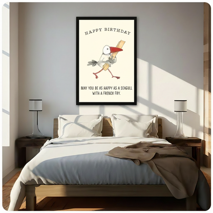 Framed canvas wall art of a cartoon seagull holding a french fry with Happy Birthday text and may you be as happy as a seagull with a french fry quote, hand-drawn illustration on cream background, above a bed with white linen bedding, a taupe throw blanket, dark wood nightstands and white table lamps in a sunlit bedroom