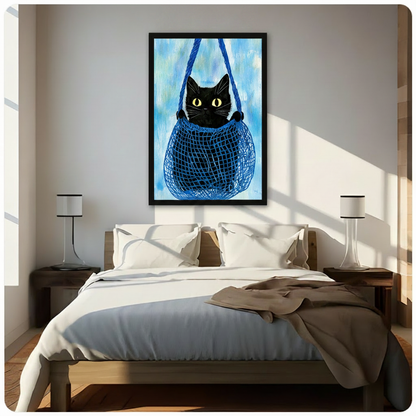 Charming black cat sitting in a blue net bag wall art in black frame, hung above a bed in a bright sunlit Scandinavian-style bedroom with white bedding