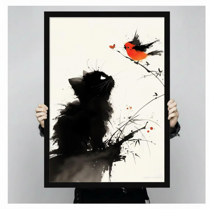 Two hands holding a large black framed ink wash black cat looking up at a red-breasted bullfinch on a branch canvas art print with white background and red butterfly accent, front-facing vertical product size display