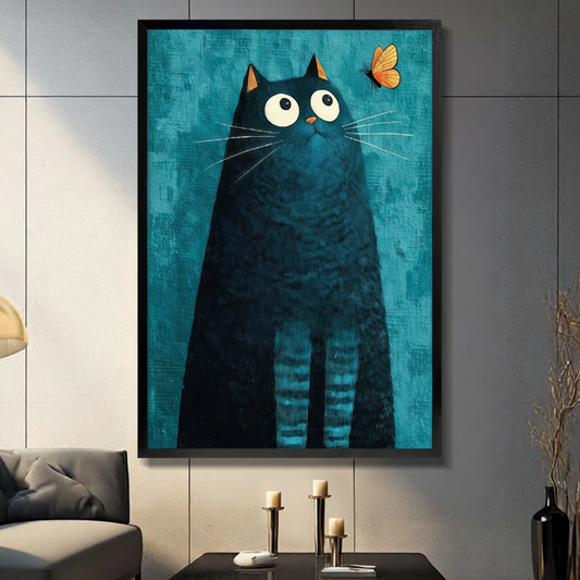 Framed modern whimsical impasto oil painting chubby black cat with oversized round white eyes and orange-tipped ears gazing upward at small orange butterfly hovering in upper right corner on deep teal blue textured brushstroke background canvas print on dark grey tile wall in modern living room with charcoal sofa and brass candlestick holders on coffee table - curious black cat butterfly teal wall art for contemporary home decor