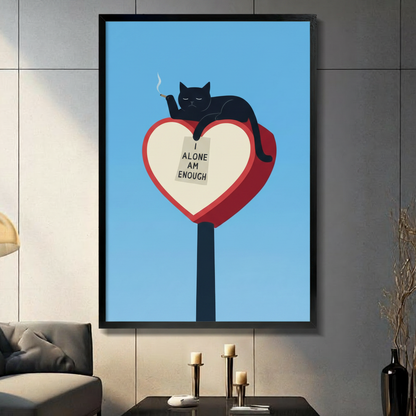 Black cat lounging on red heart sculpture "I Alone Am Enough" framed wall art in a dark modern living room