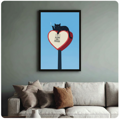 Black cat I Alone Am Enough quote art print in black frame above a sage green sofa in cozy living room