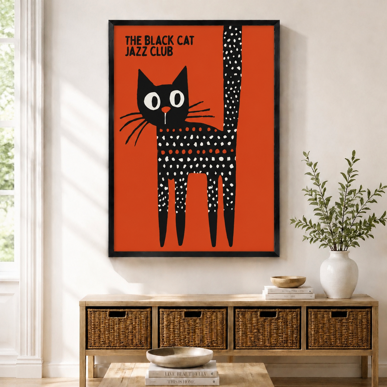 The Black Cat Jazz Club framed wall art print displayed above a wooden sideboard with wicker baskets, bold orange and black retro cat poster
