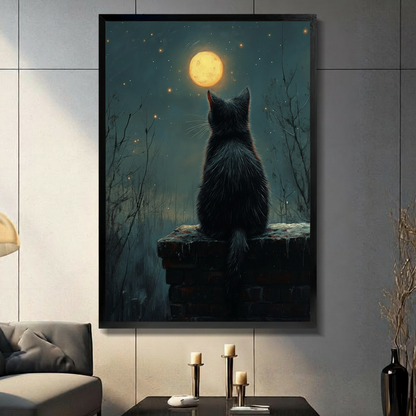 Framed canvas wall art of a black cat gazing at the full moon on a starry night, displayed in a moody living room with dark wall and candles