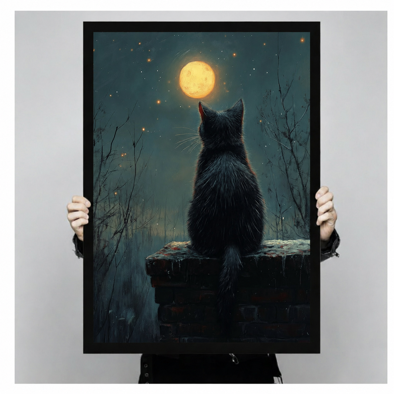 Person holding a framed black cat moongazing canvas print showing actual print size, dark atmospheric night scene wall art