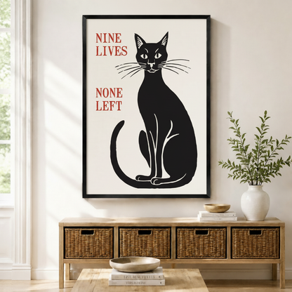Nine Lives None Left black cat framed canvas print displayed above wicker storage bench in a modern American entryway
