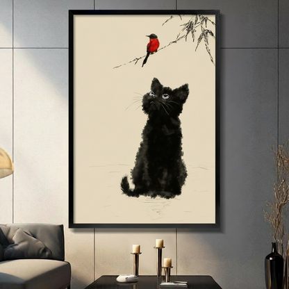 Chinese ink wash illustration of a fluffy black kitten sitting and gazing up at a small red-breasted bird perched on a bamboo branch against a warm cream paper background elegant cat and bird wall art framed print in a living room with dark gray panel wall dark sofa and black vase
