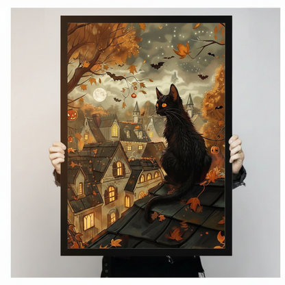 Atmospheric Halloween illustration of a sleek black cat with glowing amber eyes perched on roof tiles above a warmly glowing gothic village surrounded by autumn leaves flying bats pumpkin string lights and a large full moon in a misty starry sky Halloween cat wall art framed print held against a light gray background