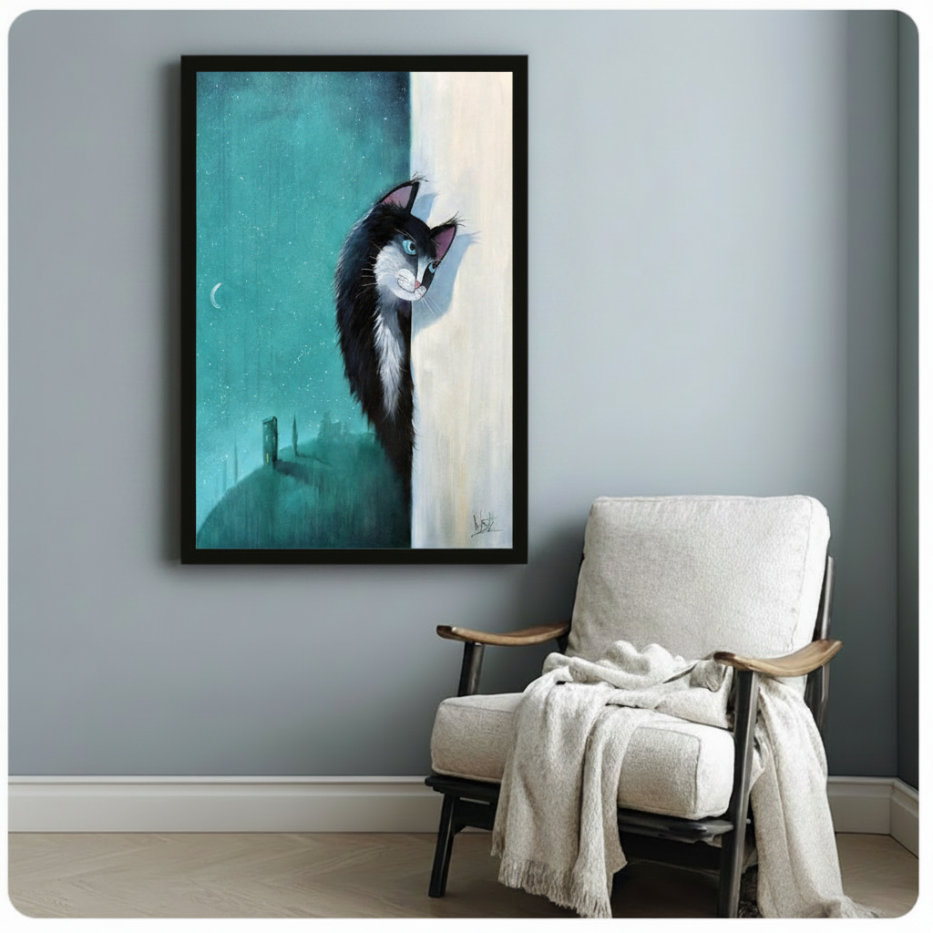 Framed art print of black tuxedo cat against teal night sky with crescent moon hung above armchair in grey room