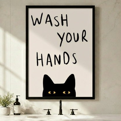 Funny black cat wash your hands framed wall art above minimalist white bathroom sink - humorous cat bathroom decor with bold hand-lettered typography