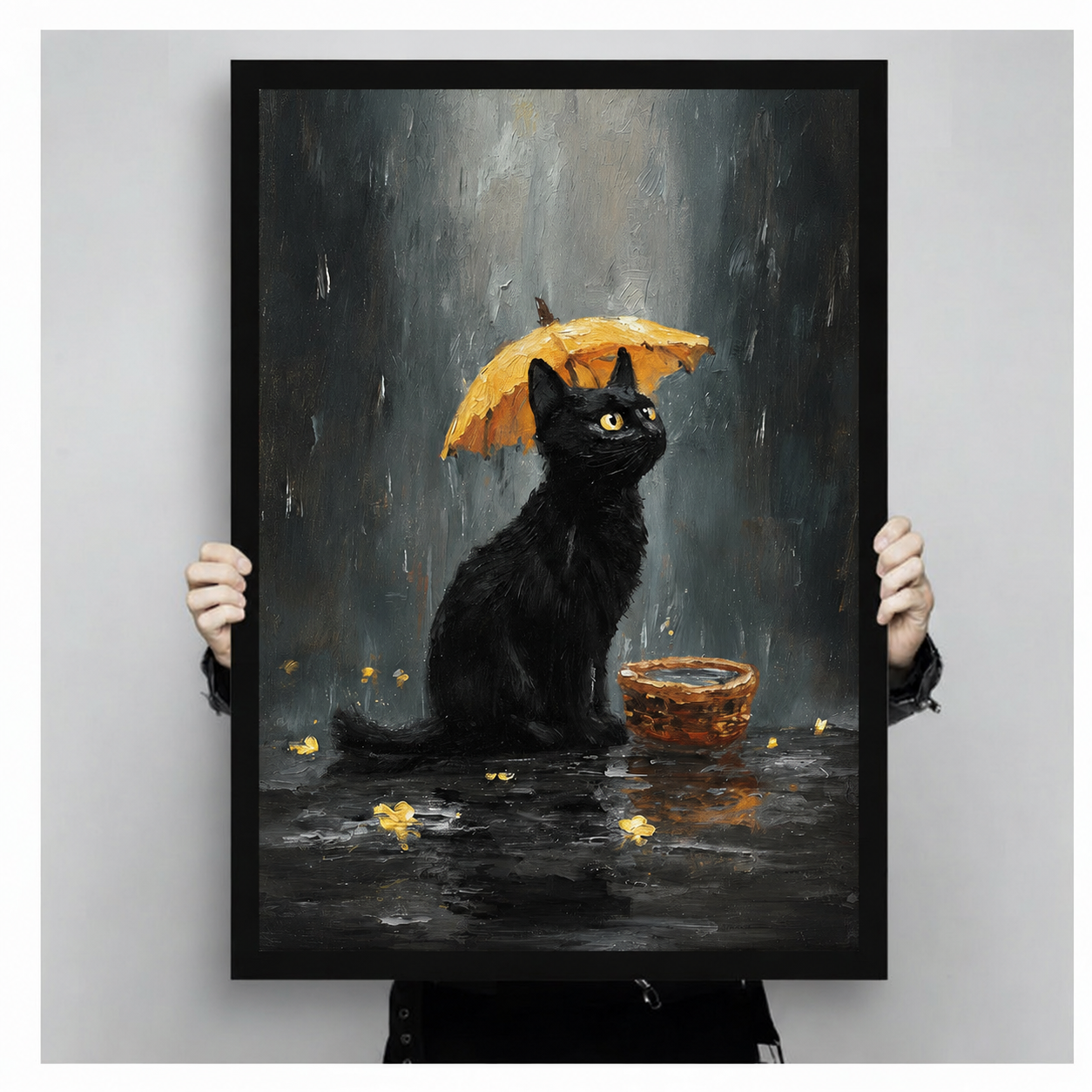 Hand-held framed print showing a black cat with golden eyes beneath a yellow umbrella in the rain, dark moody oil painting style with golden petal details