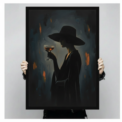 Black framed witch wall art showing a silhouetted figure holding a cocktail above a modern console table.