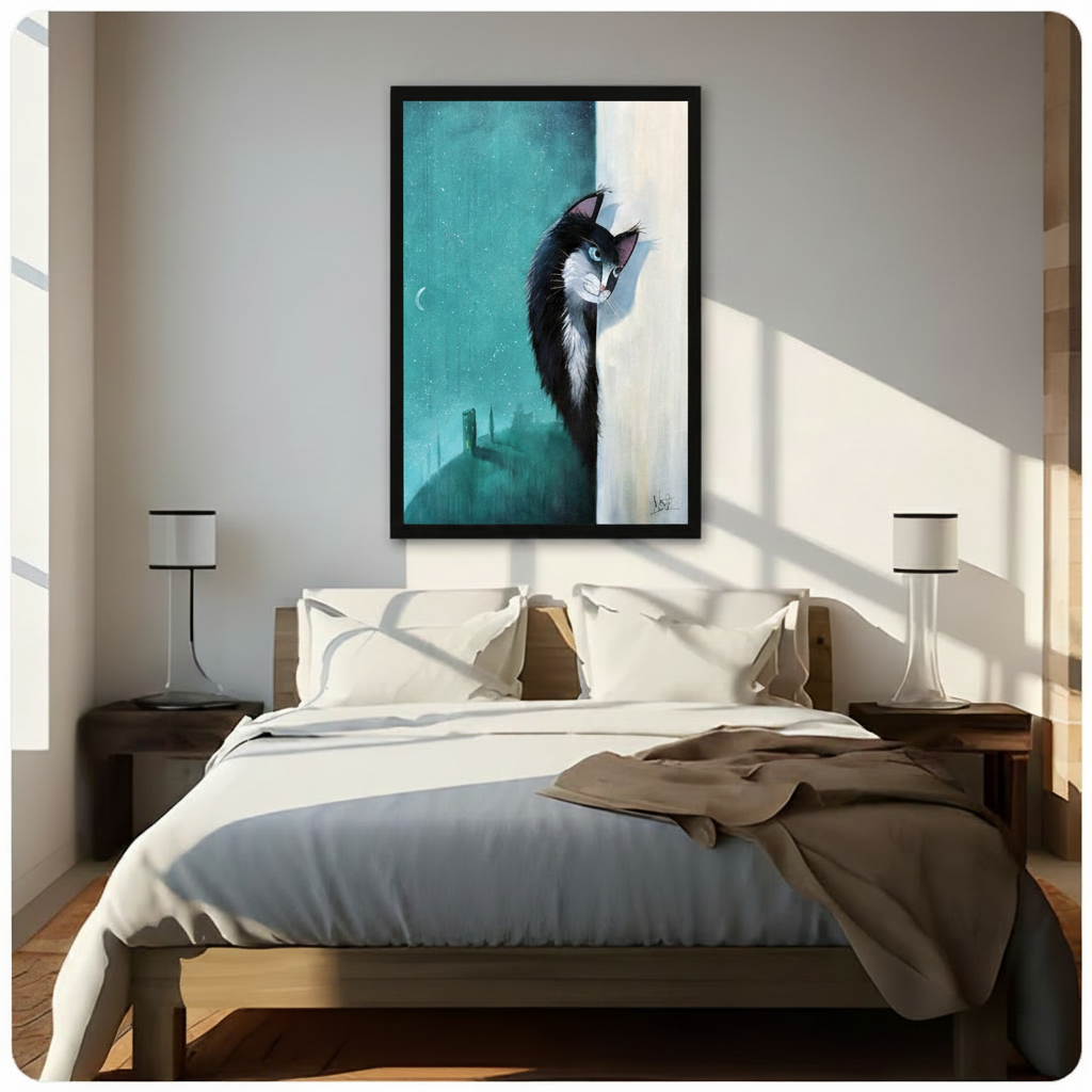 Framed wall art of black and white cat peering around edge with teal moonlit castle scene above bed in bright bedroom
