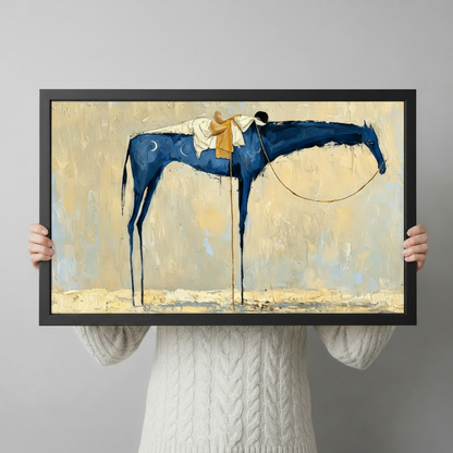 Person in white knit sweater holding a large black framed abstract blue horse and rider canvas art print against a neutral gray background, horizontal product size reference display