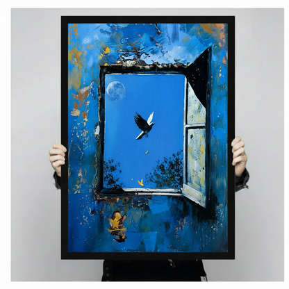 Person holding a large black framed surreal oil painting print of a weathered blue wall with an open window, flying bird, crescent moon, and a tiny musician figure, shown against a neutral gray background