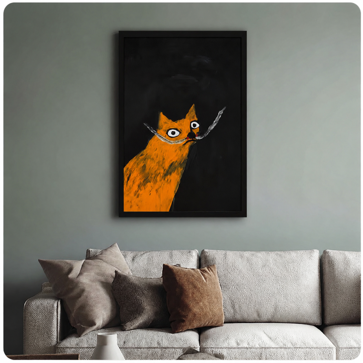 Bold orange cat with wild whiskers in black frame above a neutral linen sofa on a sage grey accent wall