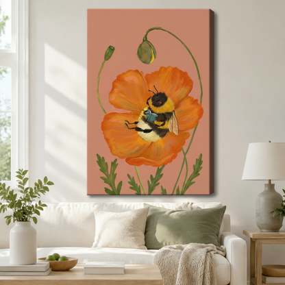 Gallery wrap canvas of a detailed bumblebee nestled in a large orange poppy bloom with green foliage on a blush pink background, hung above a white linen sofa in a Scandinavian living room