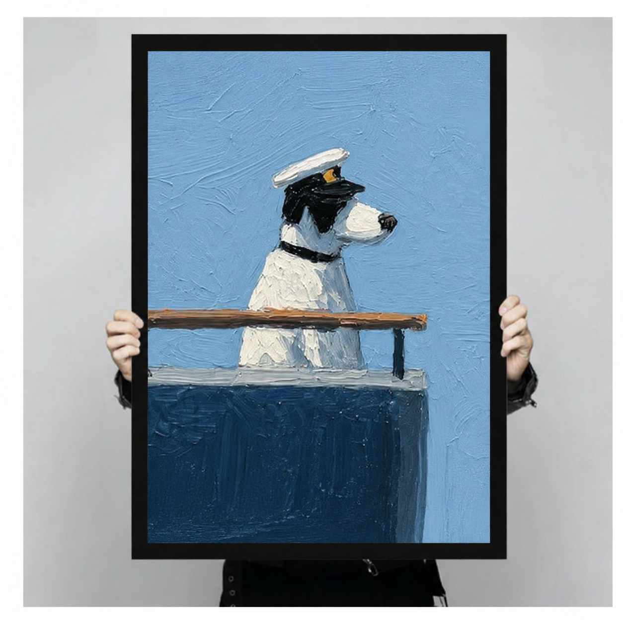 Close-up of a framed captain dog art print being held by hand, showing thick impasto oil texture and nautical blue tones