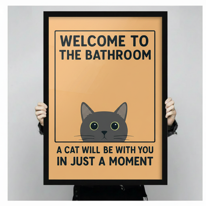 Person holding large framed cat bathroom print showing size — Welcome to the Bathroom funny wall art for cat lovers