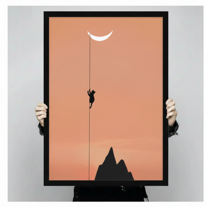 Two hands holding a black-framed minimalist canvas print of a cat climbing toward the moon, showing print size and frame quality