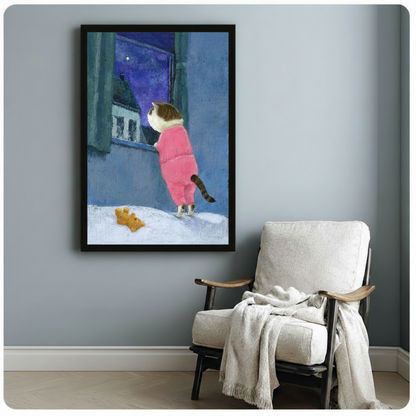 Whimsical framed art print of a tabby cat in pink sleepwear peering through a winter window, hung on a blue-grey wall beside a linen armchair with a throw blanket