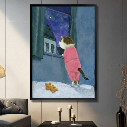 Framed wall art print of a chubby cat in pink pajamas gazing out a snowy window at the starry night sky, displayed on a dark grey wall above a console with candle holders