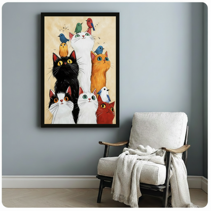 Whimsical cats and colorful birds framed art print on blue-grey wall beside white accent chair with throw blanket