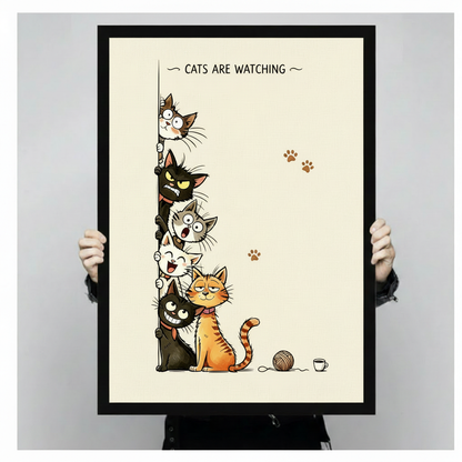 Bold funny cat cartoon art print titled cats are watching depicting six cats of different breeds and personalities stacked and peeking around the left edge of a vertical border with a startled gray tabby at the top a glowering black cat with bright eyes below a bewildered round-eyed gray cat then a gleefully laughing white cat a sleepy contented orange striped tabby cat in the foreground and a creepily smiling black cat at the bottom three brown paw prints on the right side and a yarn ball plus tiny coffee 