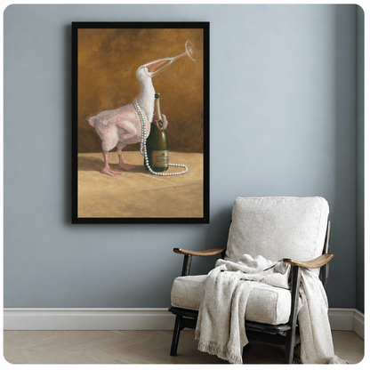 Black-framed funny duck and champagne wall art on a blue wall beside a cozy white armchair.
