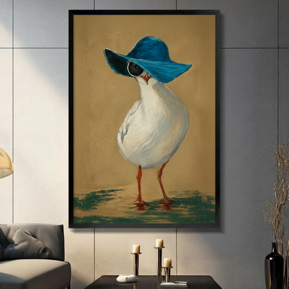 Framed wall art print of a stylish seagull wearing a wide-brim blue hat and sunglasses, displayed in a modern dark-toned living room
