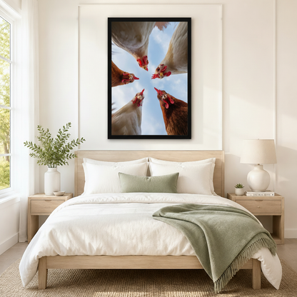 Striking framed farm animal wall art of five white and brown chickens with vivid red combs staring down from a bright blue sky in a dramatic low-angle perspective, displayed above a white and sage linen bed in a serene Scandinavian bedroom