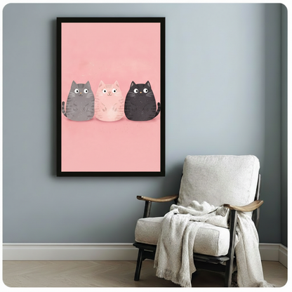 Black framed chubby cartoon cats trio poster on pink background hanging above white linen accent chair in cozy room