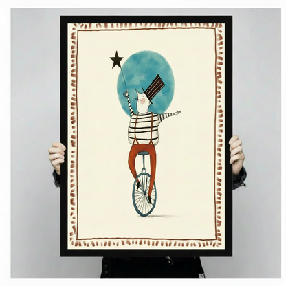 Hand-held black framed circus unicycle art print showing full artwork detail and frame quality