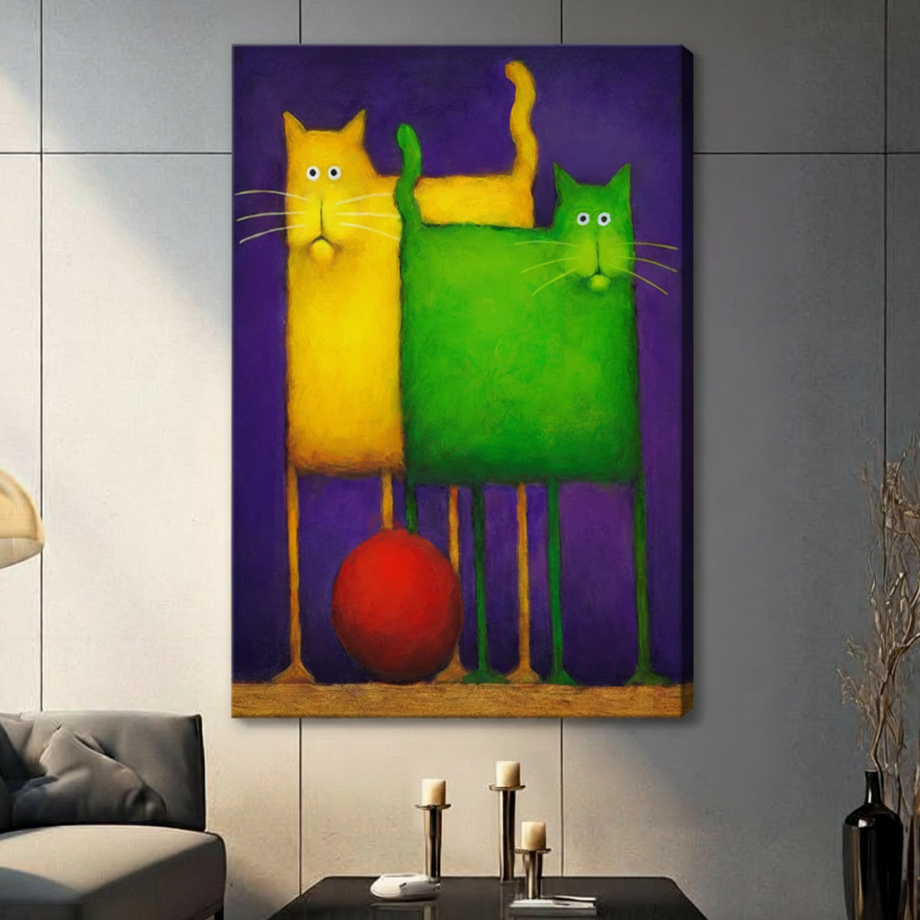 Stretched canvas wall art featuring two quirky abstract cats side by side — a tall slender yellow cat and a wide blocky green cat — with a vivid red ball nestled between their spindly legs on a rich violet background, hung on a gray tile wall beside a modern charcoal sofa with candlestick decor