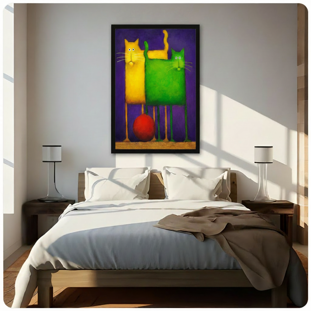 Black framed bold abstract yellow and green cat duo with red ball canvas art hung above a wooden bed frame in a sun-drenched minimalist bedroom with crisp white linen bedding, matching cylindrical nightstand lamps, and warm natural light casting diagonal shadows across the wall