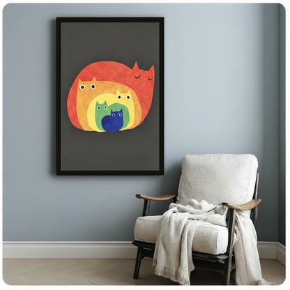 Black framed canvas of a playful nesting cat illustration with five cats in red, orange, yellow, green, and blue layered inside one another, mounted on a blue-grey wall beside a linen armchair