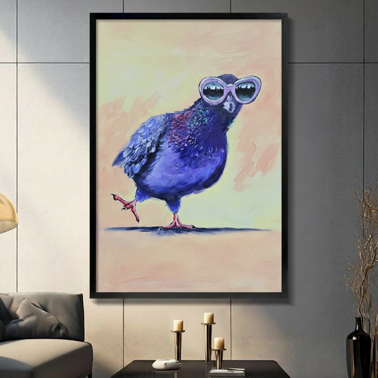 Humorous impasto oil painting of a chubby deep blue-purple pigeon strutting with one leg raised wearing oversized white cat-eye sunglasses reflecting a city skyline on a warm beige and yellow-green gradient background bold expressive brushwork funny bird framed wall art print displayed in a living room with dark gray sofa, pillar candle holders, and black decorative vase