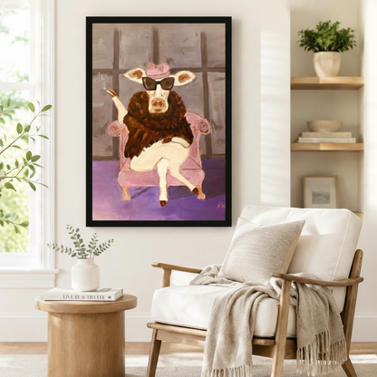 Cow with sunglasses and fur coat in pink armchair framed wall art beside reading chair — quirky animal canvas print