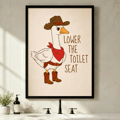 Funny cartoon illustration of a grumpy white goose in a brown cowboy hat red bandana and cowboy boots with the text Lower The Toilet Seat on a cream background funny bathroom wall art framed print above bathroom sink with black faucet and green plants