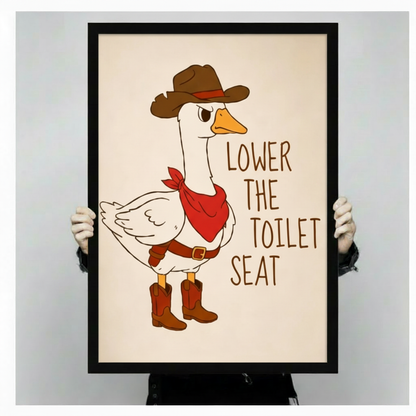 Funny cartoon illustration of a grumpy white goose in a brown cowboy hat red bandana and cowboy boots with the text Lower The Toilet Seat on a cream background funny bathroom wall art framed print held against light gray background